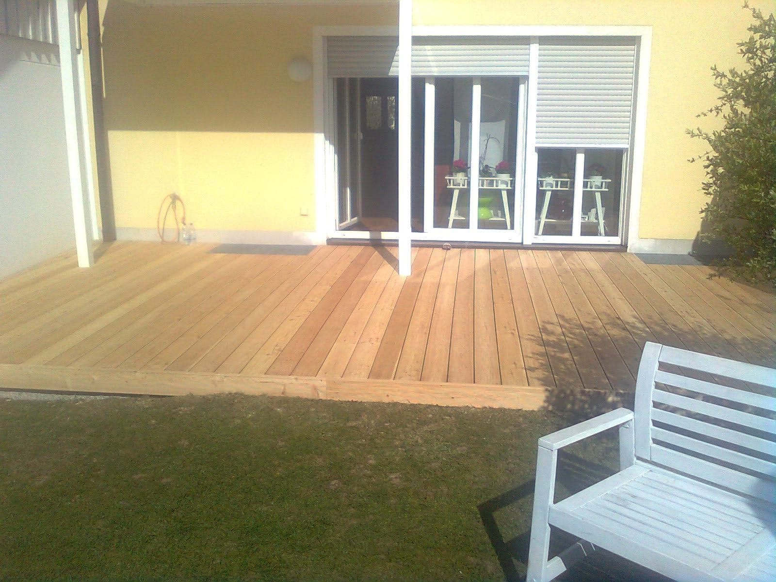 Newly built terrace with floorboards and garden
