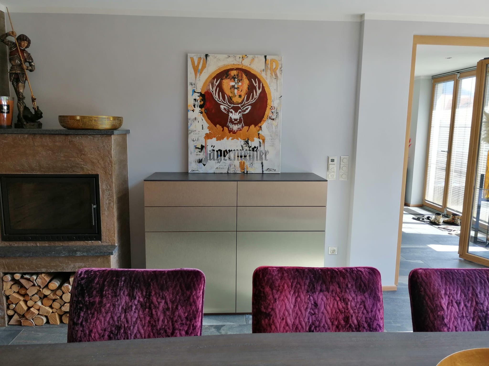 Sideboard with gold finish next to the fireplace