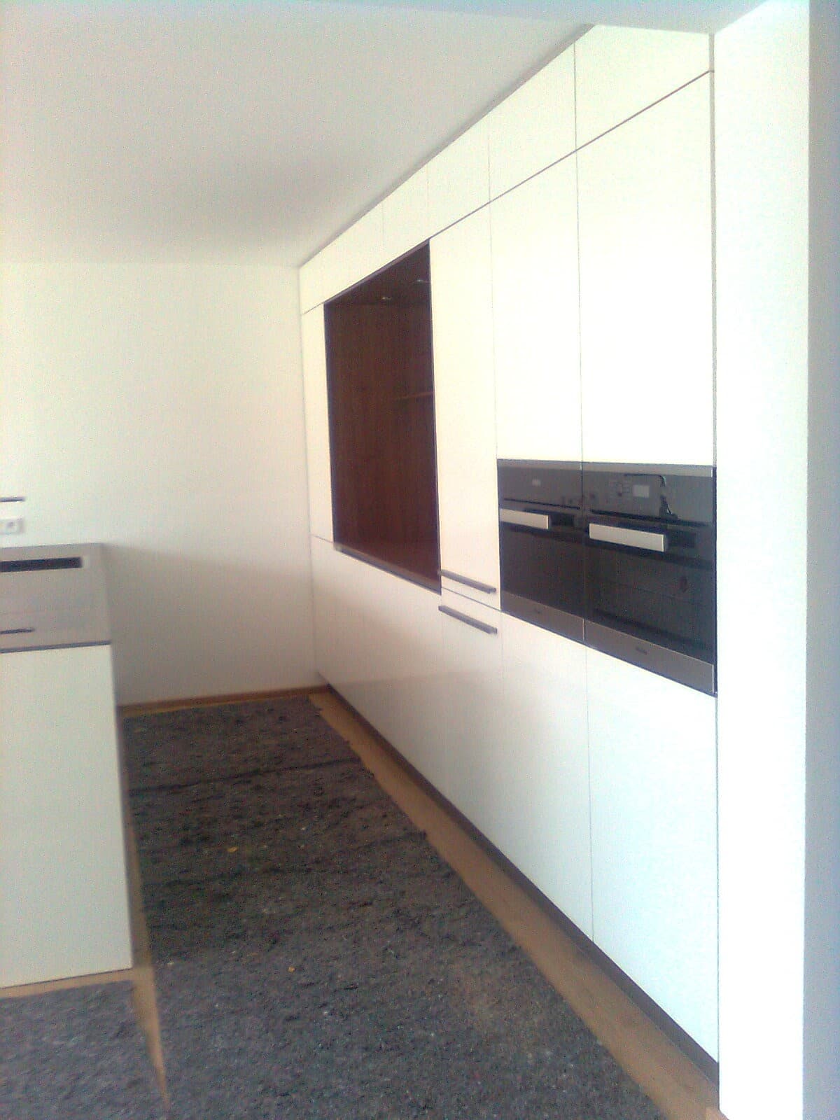White fitted kitchen with island in a new build