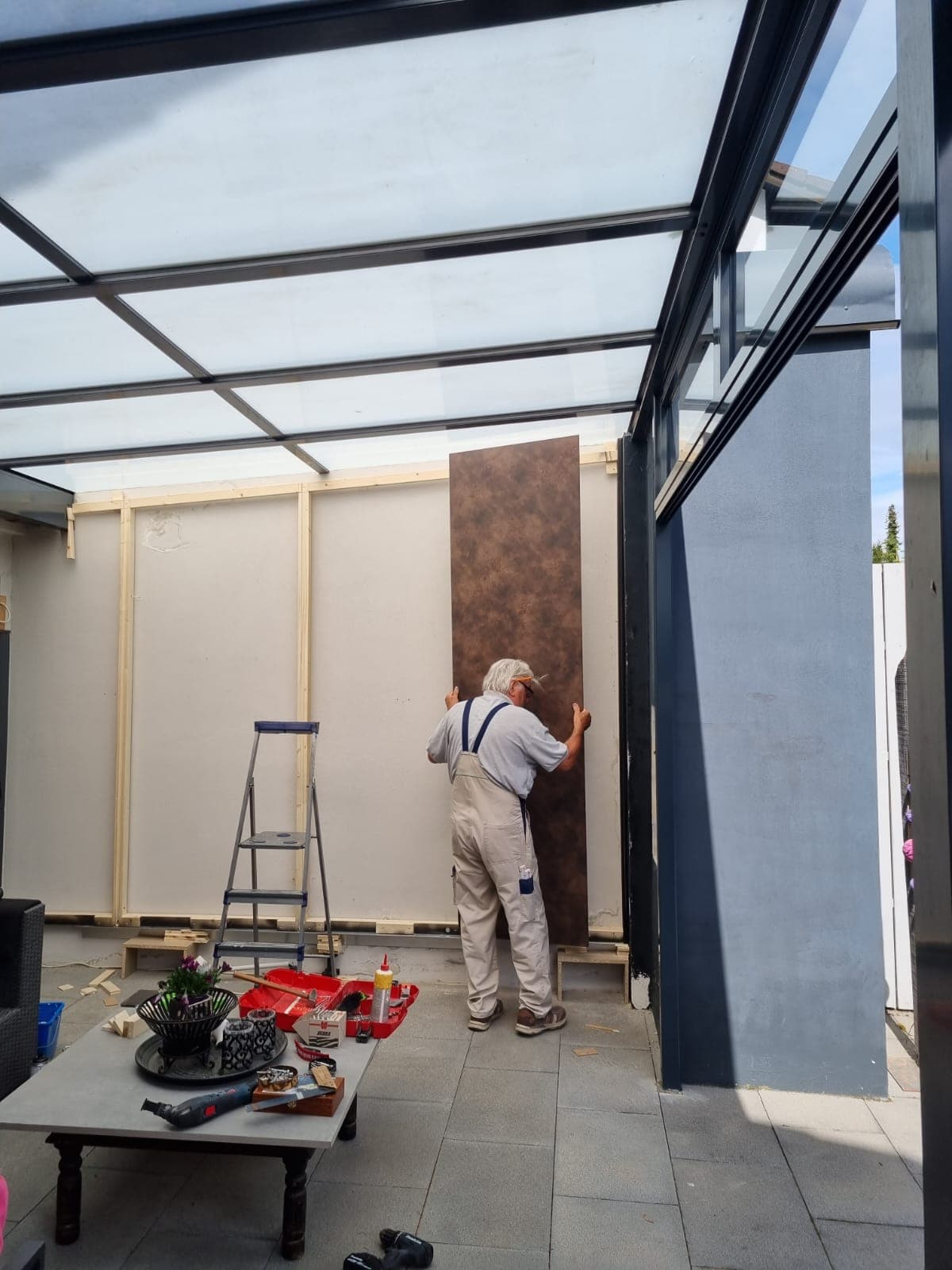 Conservatory with glass roof and wall panelling, installed by Lauer-Seele